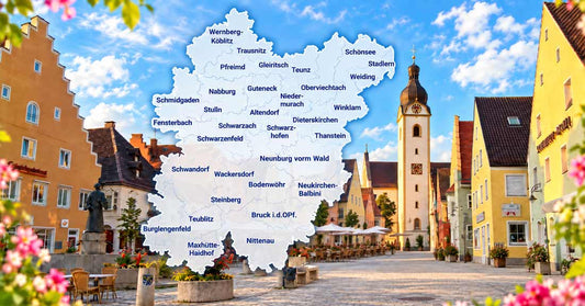 Marktplatz in Schwandorf mit Kirchturm, sommerlichem Himmel, Blumen und zentral eingeblendeter Karte des Landkreises Schwandorf.