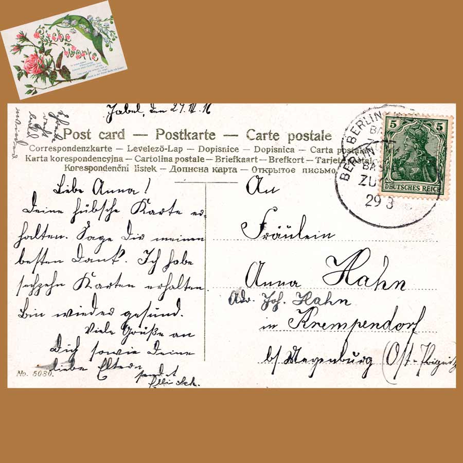 Beschriebene Rückseite einer alten Postkarte von 1911 mit Berliner Poststempel und 5-Pfennig-Briefmarke Deutsches Reich.